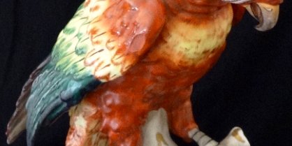 Red Parrot - Cotorra Roja Dresden with a red and green hand colored parrot on top of a tree branch and with a size of 12 inches high. Dresden con una cotorra sobre un tronco coloreada a...